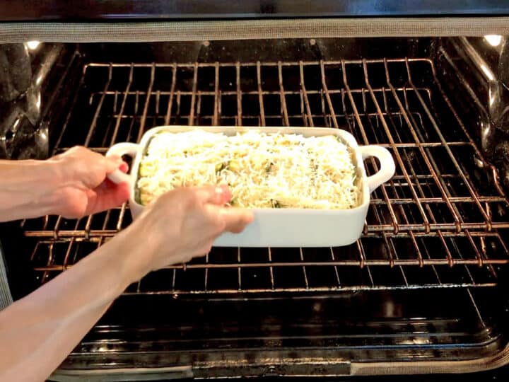 Placing the lasagna in the oven.