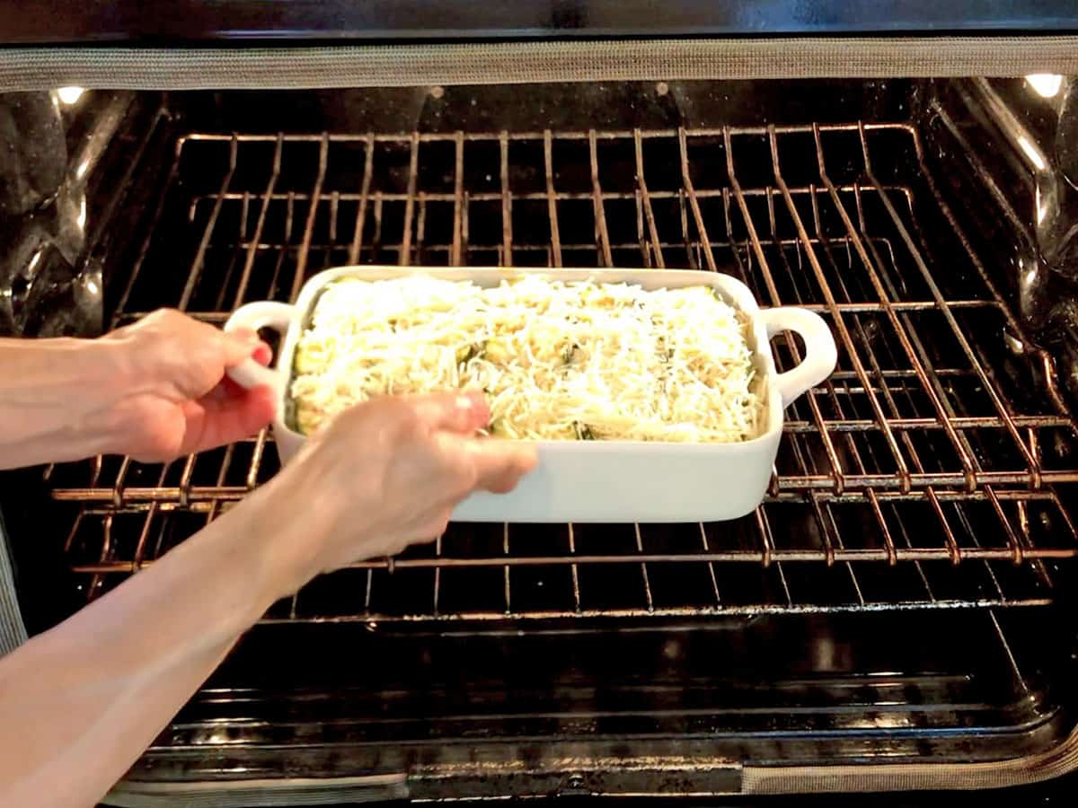 Placing the lasagna in the oven. 