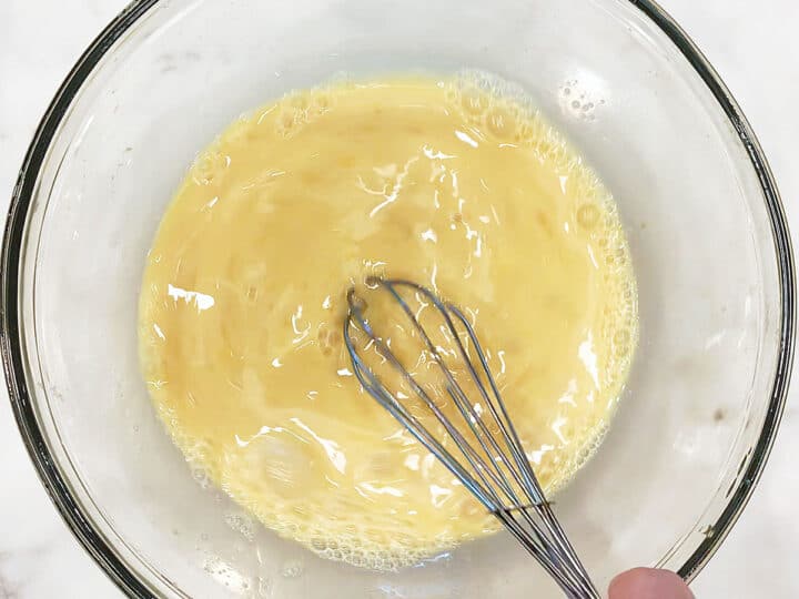 Mixing keto waffles' wet ingredients in a bowl.