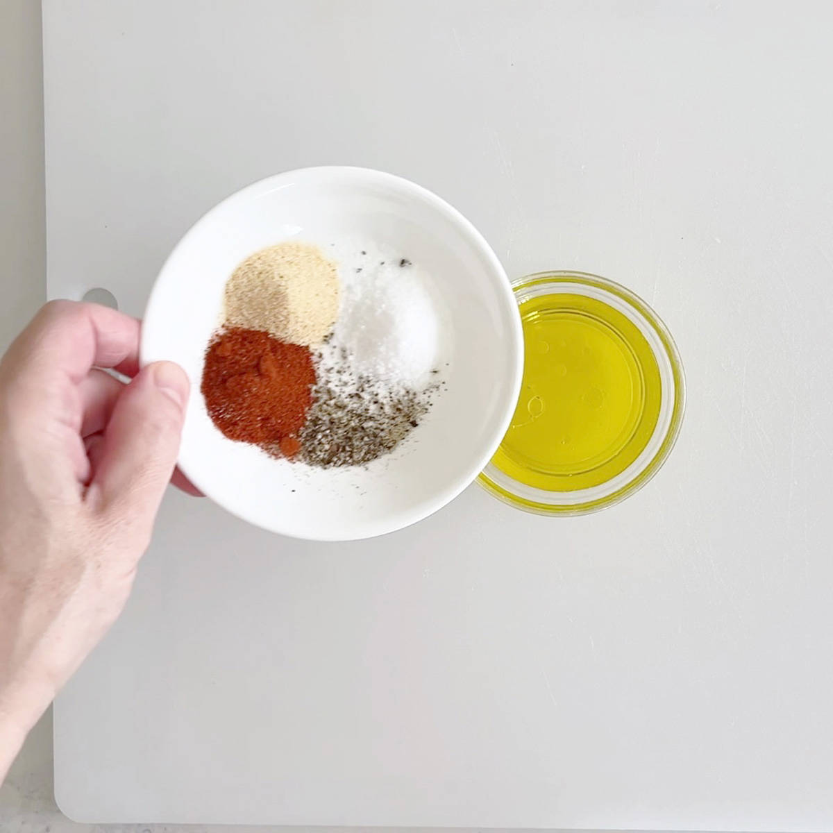 Adding spices to olive oil. 
