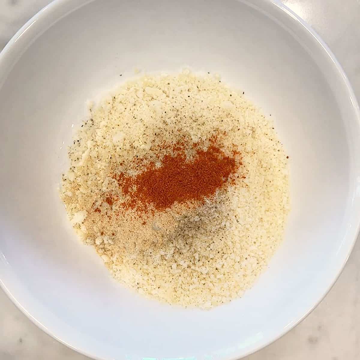 Parmesan and spices in a bowl. 