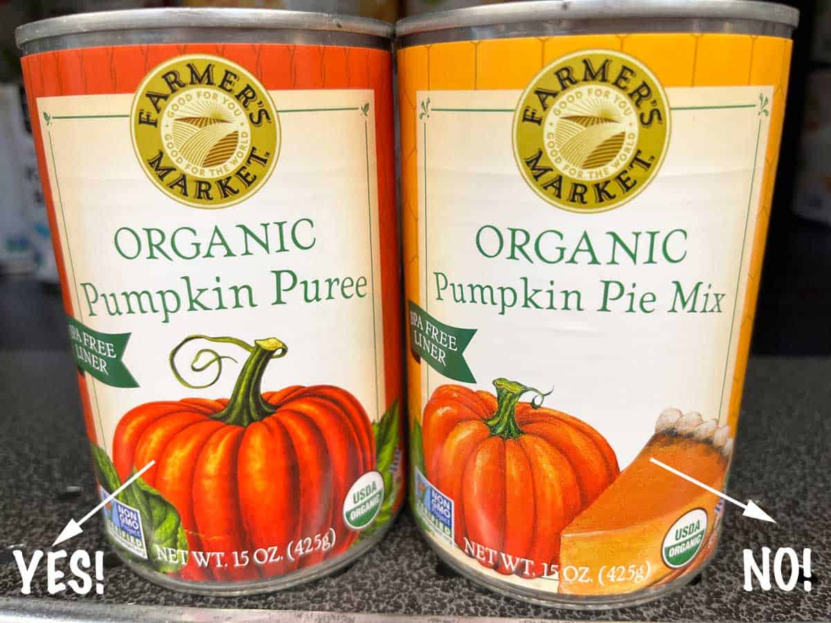 A can of pure pumpkin puree next to a can of pumpkin pie filling. 