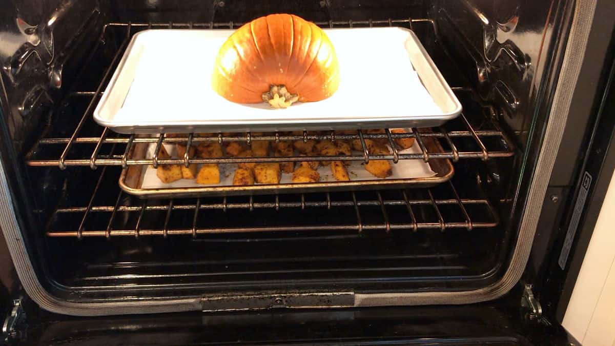 Half a pumpkin and pumpkin cubes roasted simultaneously in the oven.