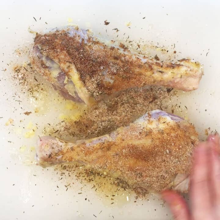Seasoning the turkey legs.