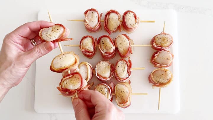 Threading the scallops on skewers.