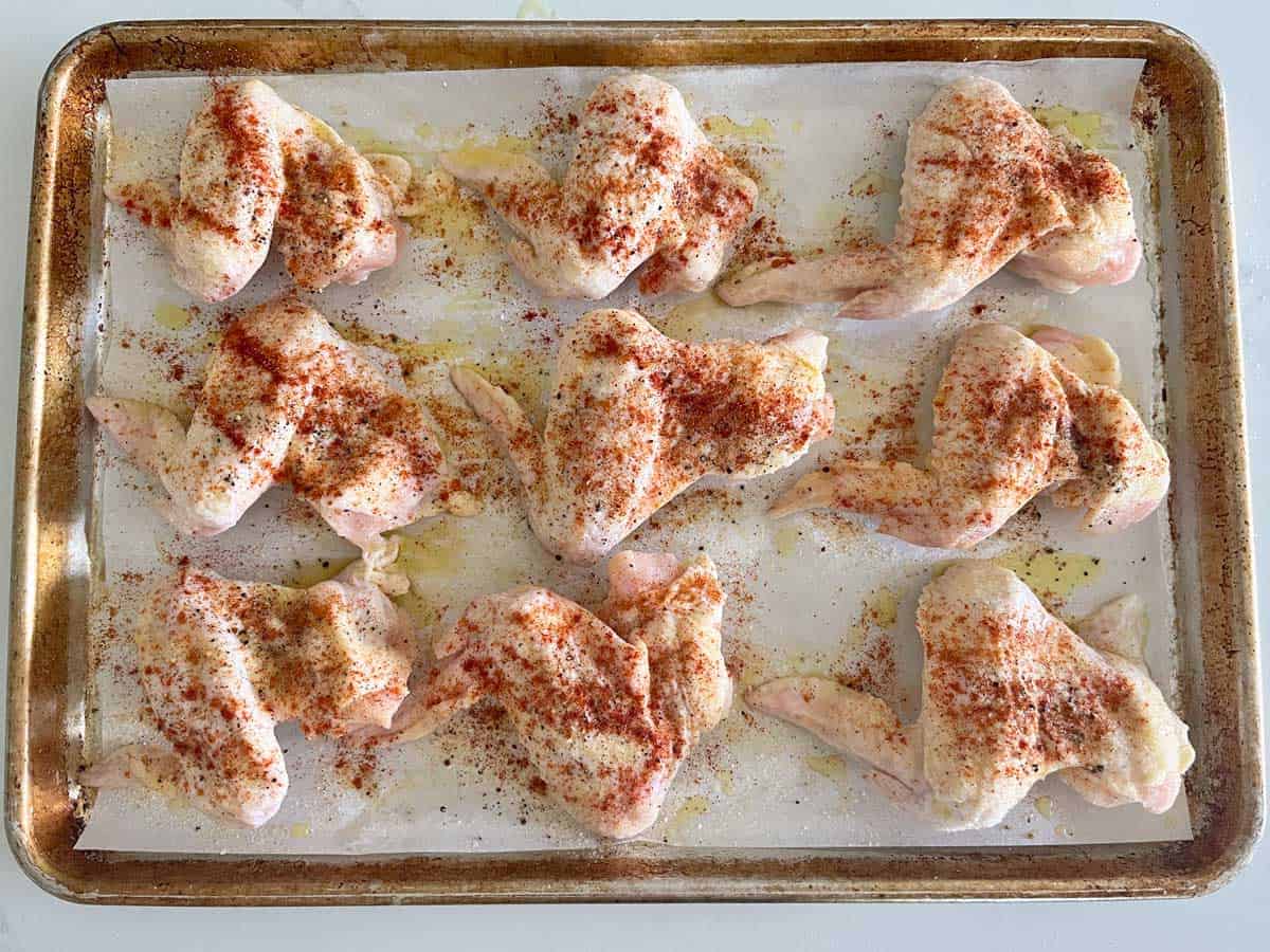 Whole chicken wings on a baking sheet. 