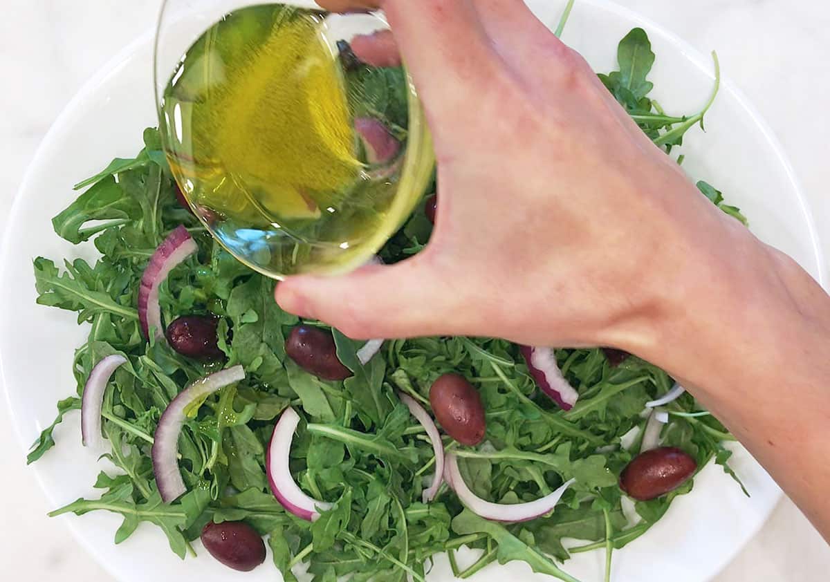 Drizzle the salad with the oil and vinegar mixture.