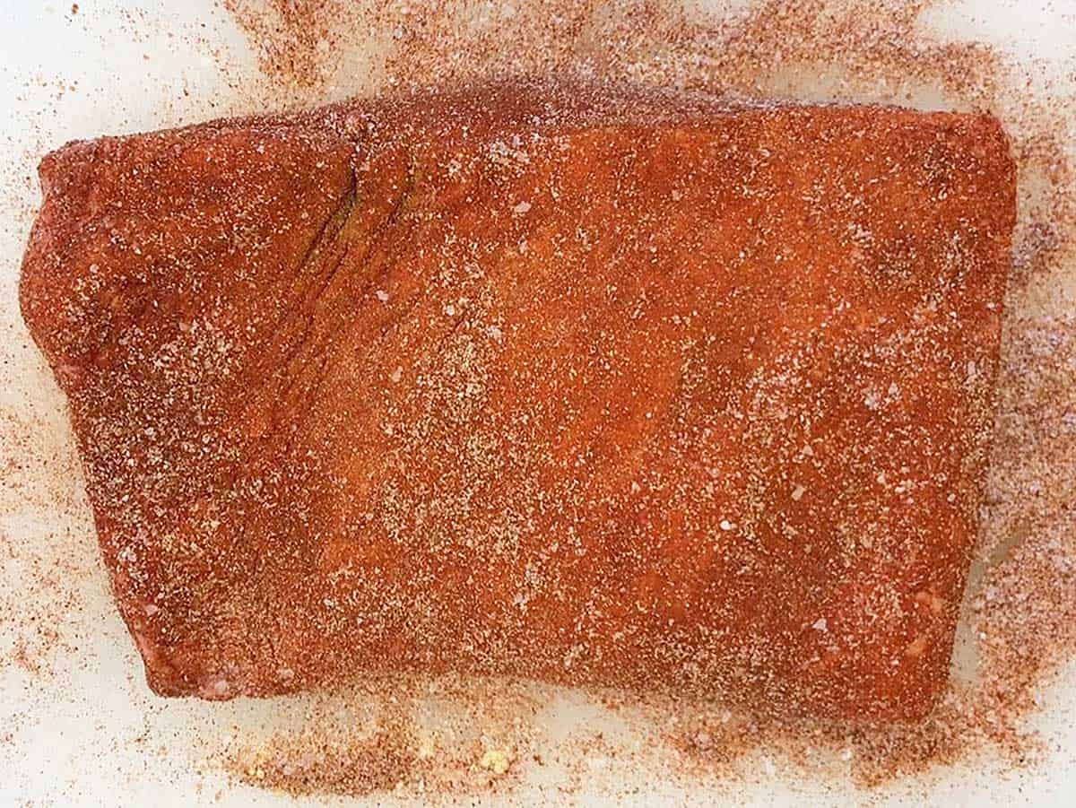 Raw brisket coated in spices. 