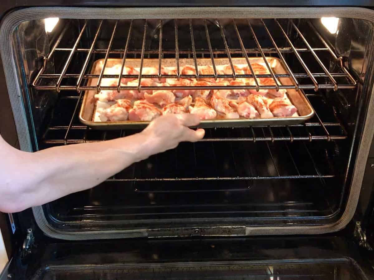 Placing the wings in the oven.