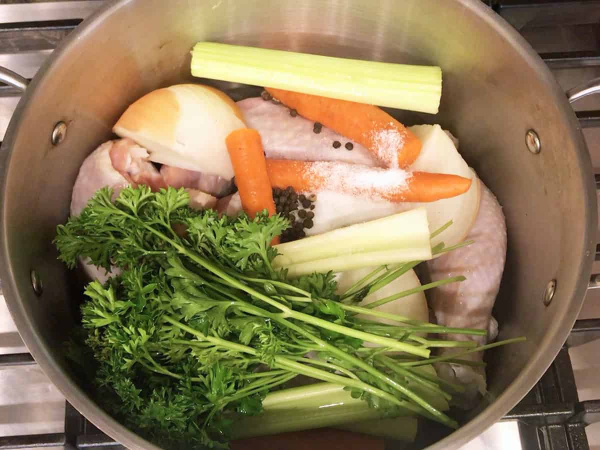 Add vegetables and aromatics to the stockpot.
