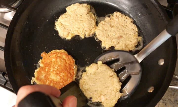 Cooking chicken patties in a skillet.