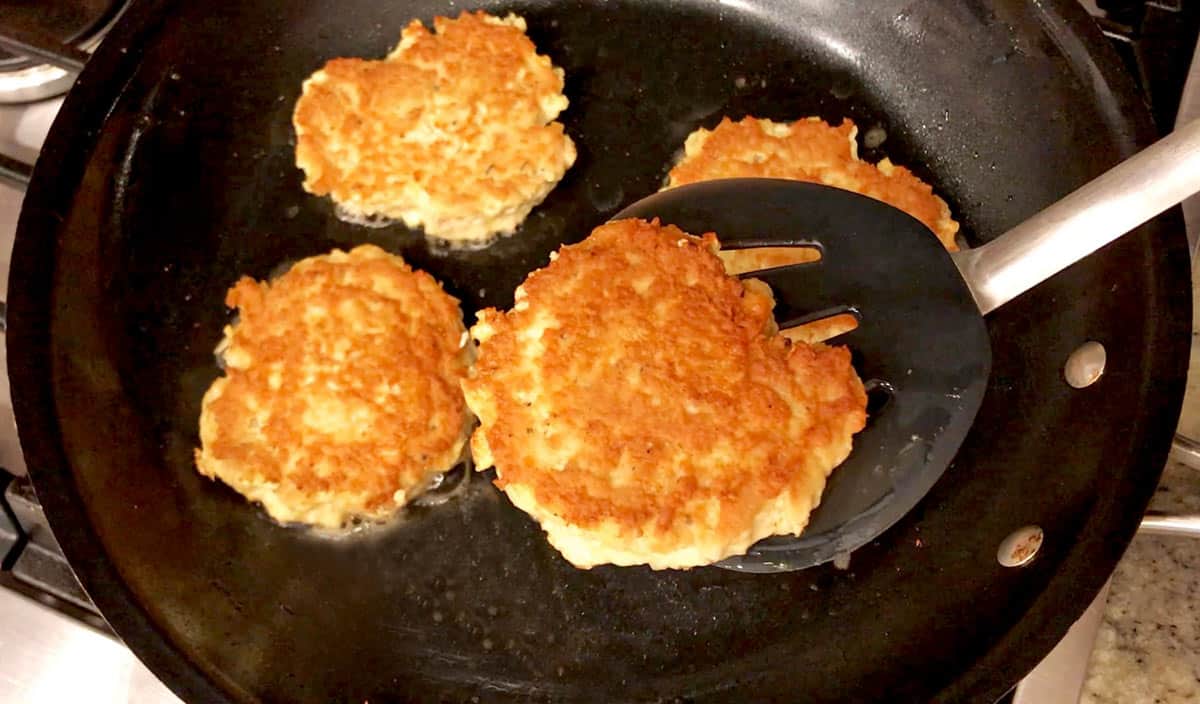 Chicken patties are ready in the skillet. 