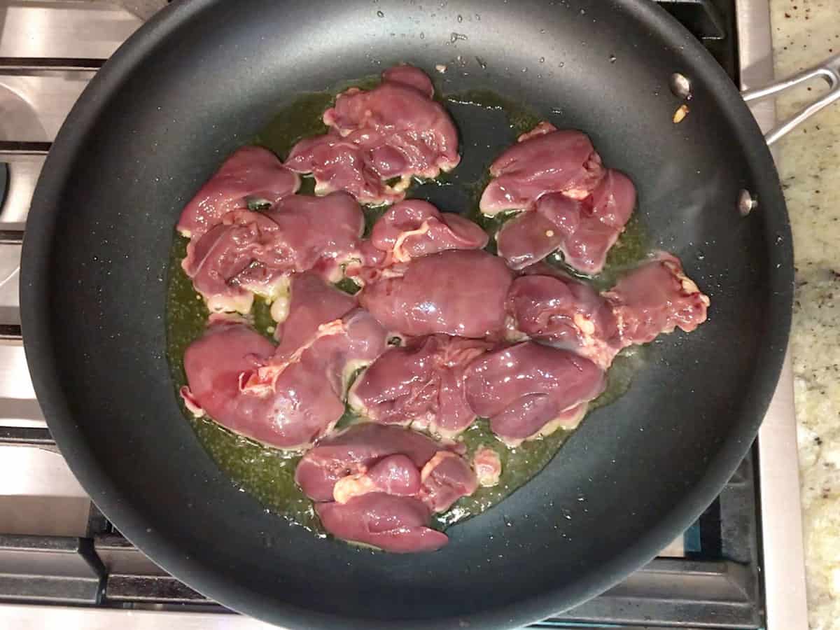 Cooking chicken livers in olive oil.