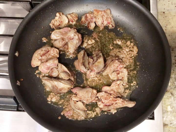 The chicken livers are cooked in the skillet.