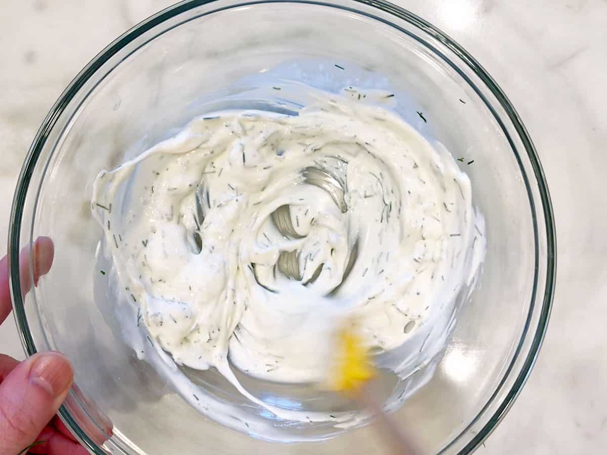 Mixing the creamy dressing in a bowl.