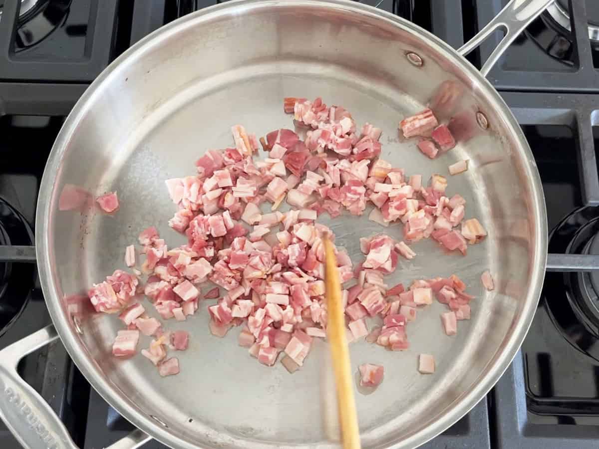 Chopped raw bacon in a skillet.
