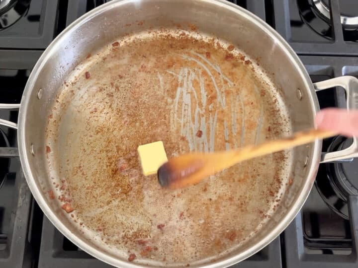 Adding butter to the skillet.