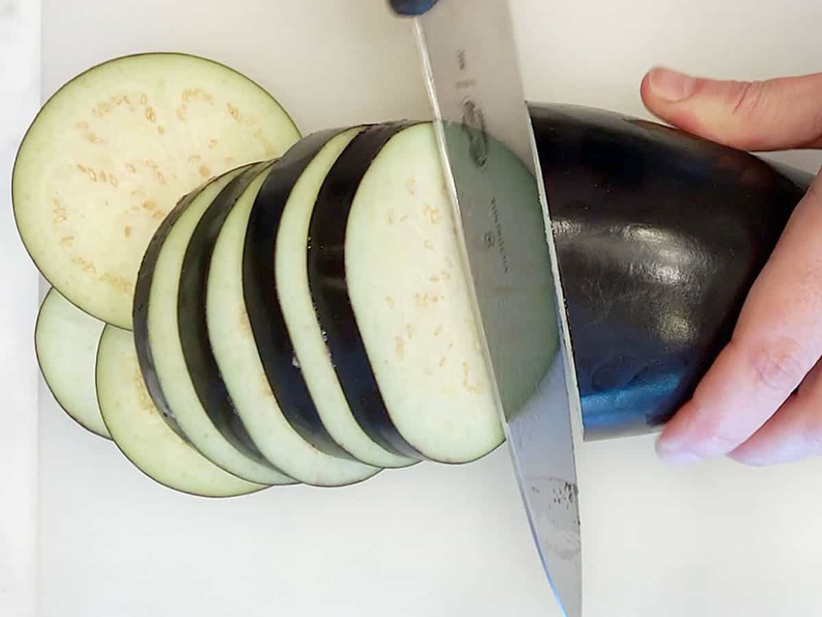 Slicing a raw eggplant.