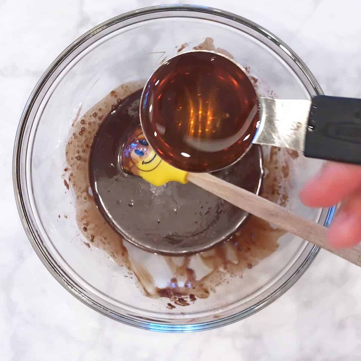 Adding honey to the mixture.