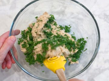 Adding parsley to the mixture.