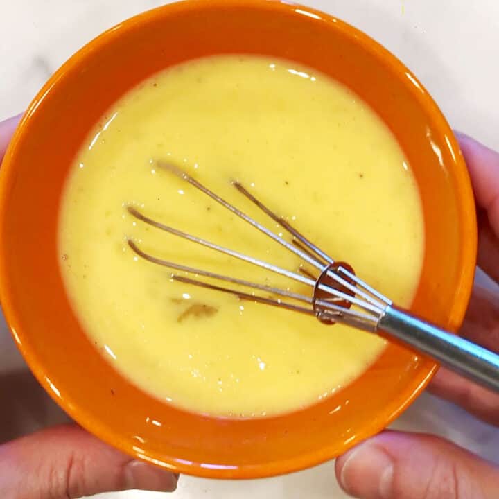 Whisking the ingredients to combine.