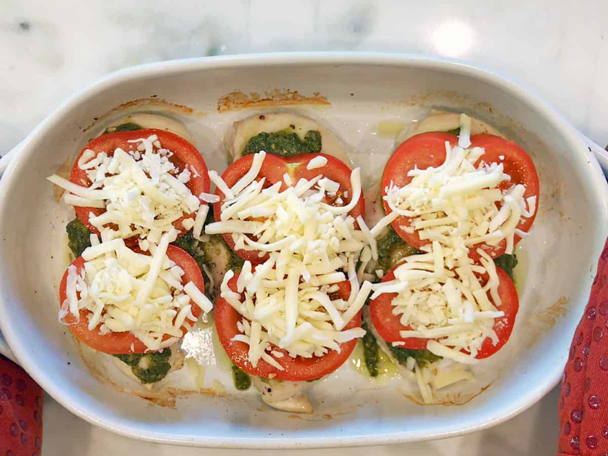 Pesto chicken topped with shredded cheese.
