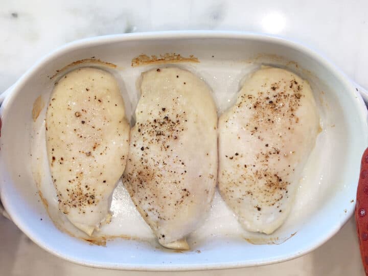 Chicken is partially baked in the pan.