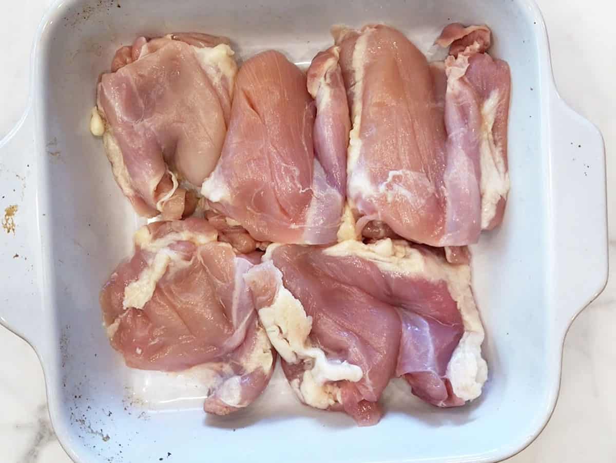 Chicken thighs in a baking dish. 