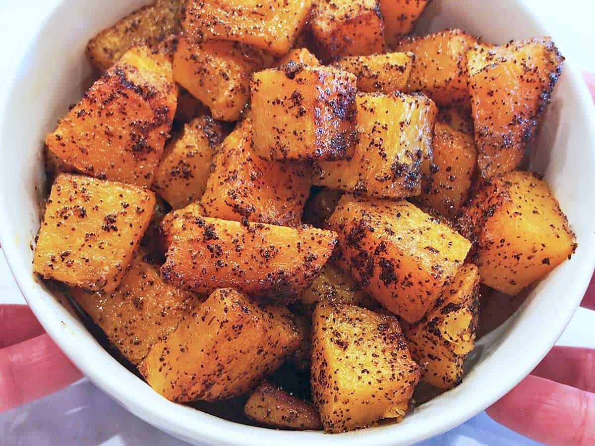 Roasted butternut squash is served in a bowl.