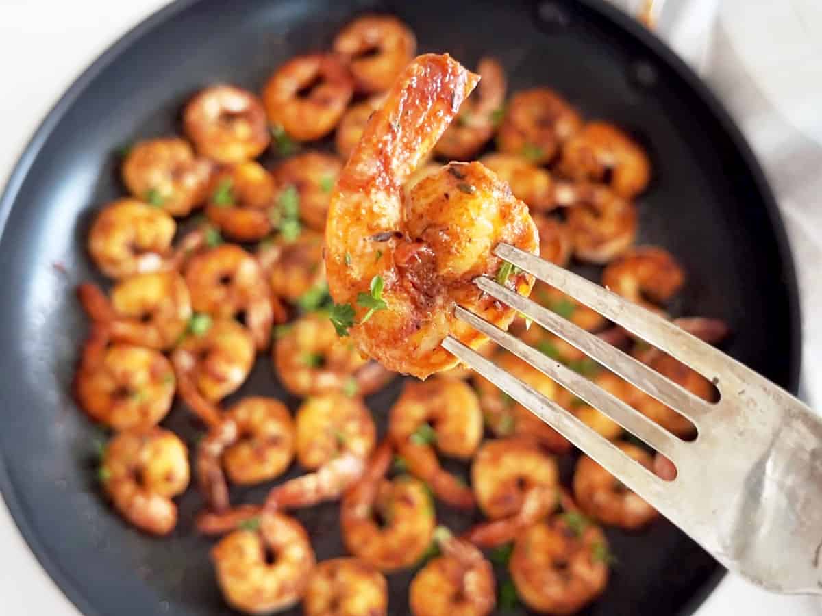 A closeup of a sauteed shrimp that shows how juicy it is.