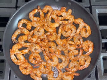 Shrimp sauteed in a skillet.