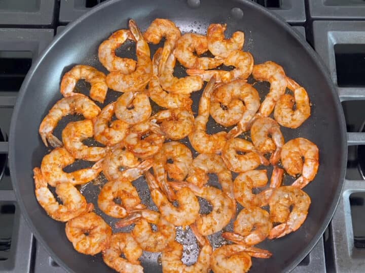 Shrimp sauteed in a skillet.
