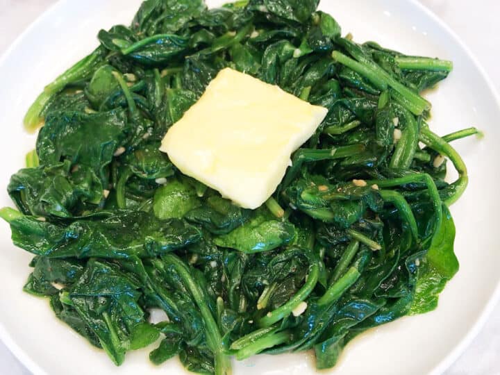 Topping sauteed spinach with butter.
