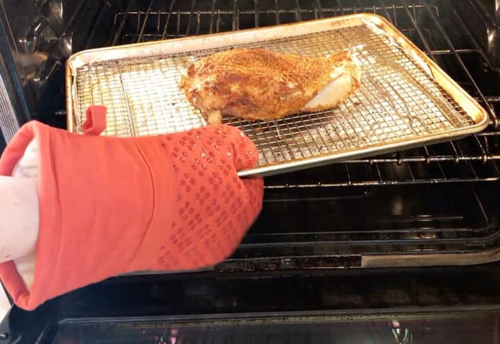Placing the turkey breast in the oven.