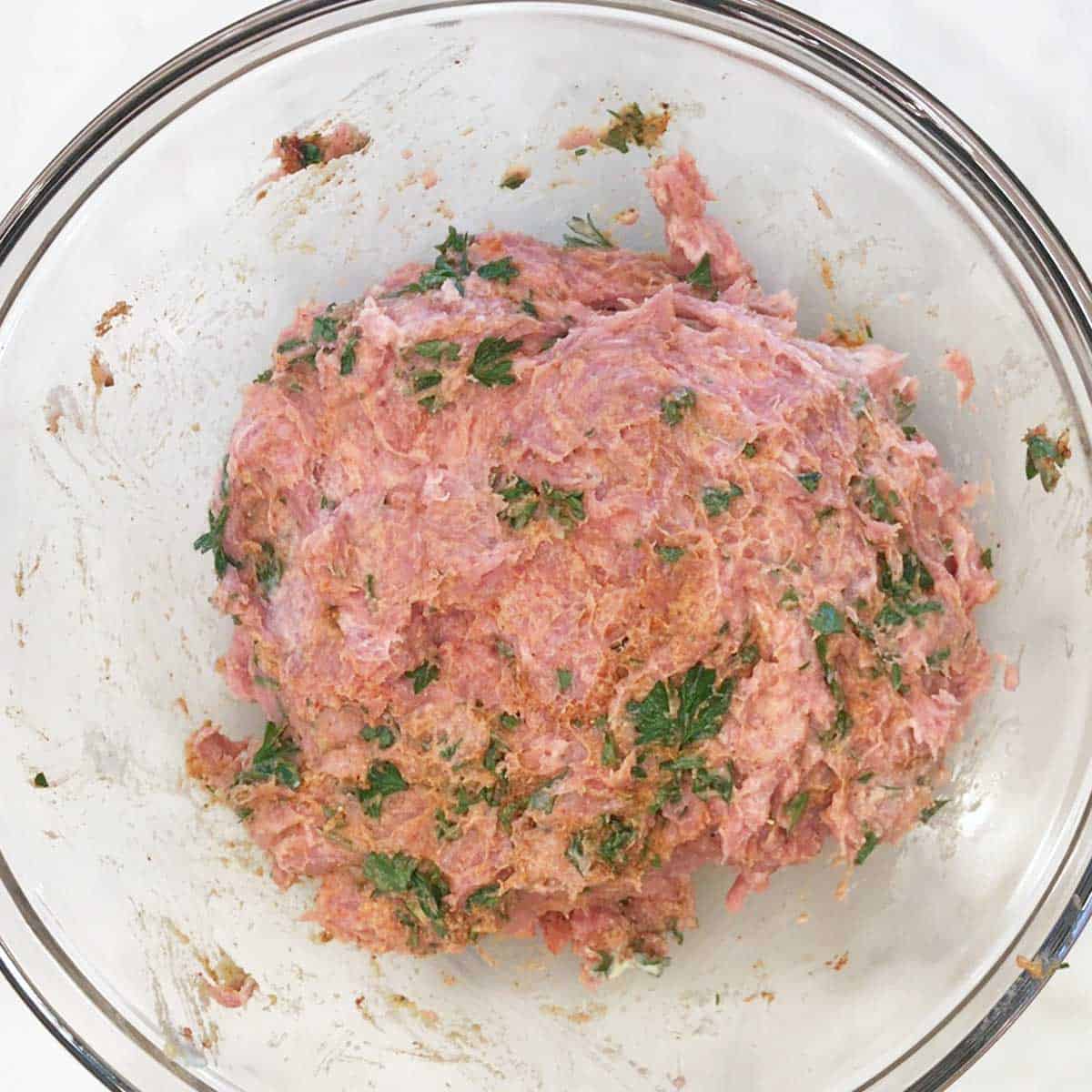 Turkey burger ingredients mixed in a bowl. 