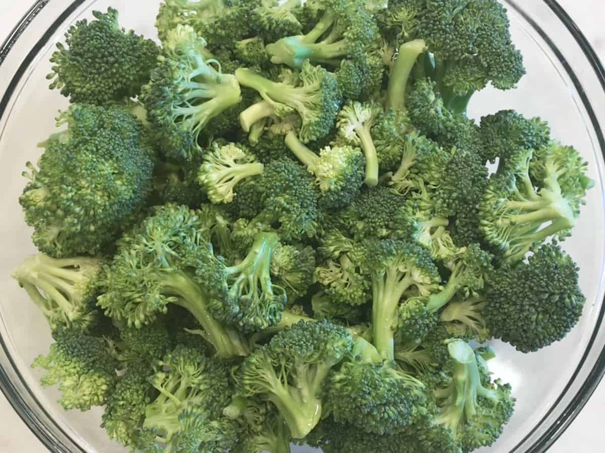 Raw broccoli florets in a bowl. 