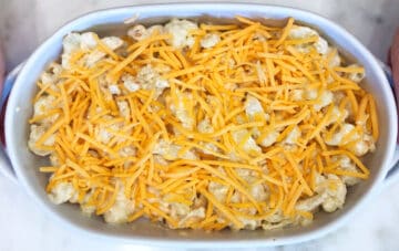 Cauliflower casserole in a baking dish, topped with cheese.