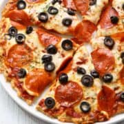 Chicken crust pizza topped with olives.