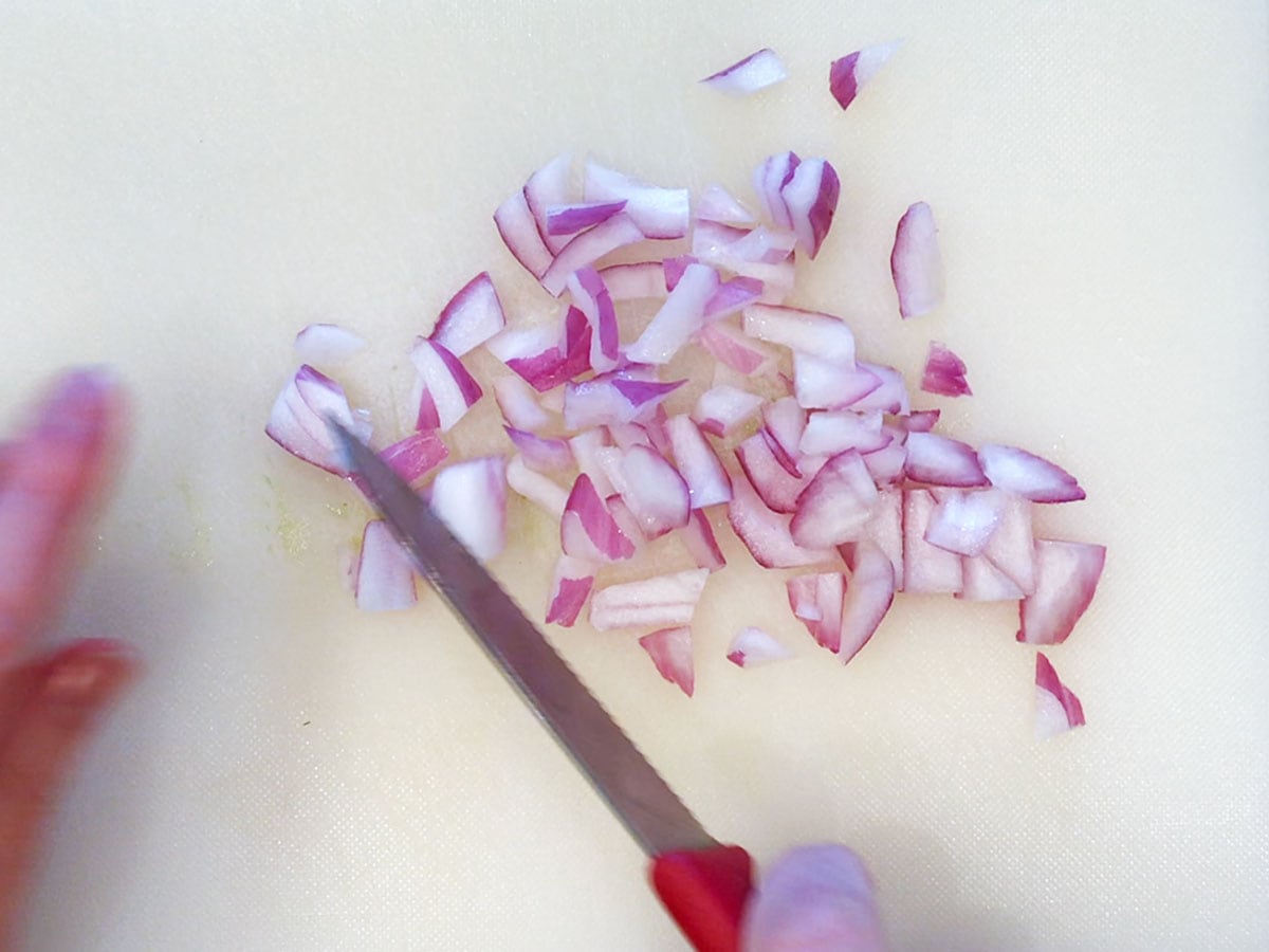 Chopping red onions.