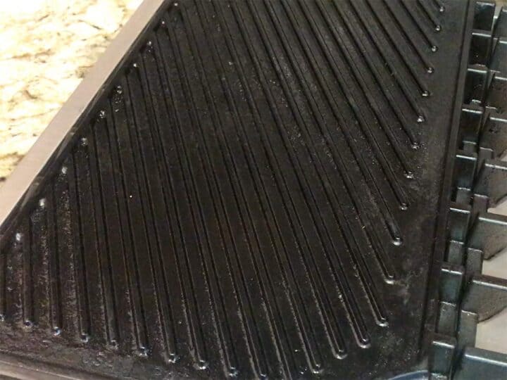 Double-burner grill pan being heated.