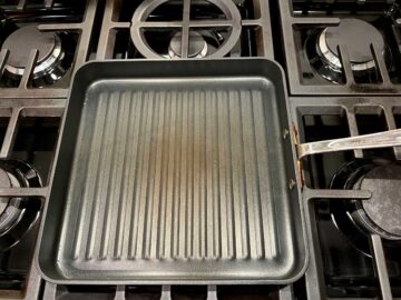 Heating a grill pan on the stove.