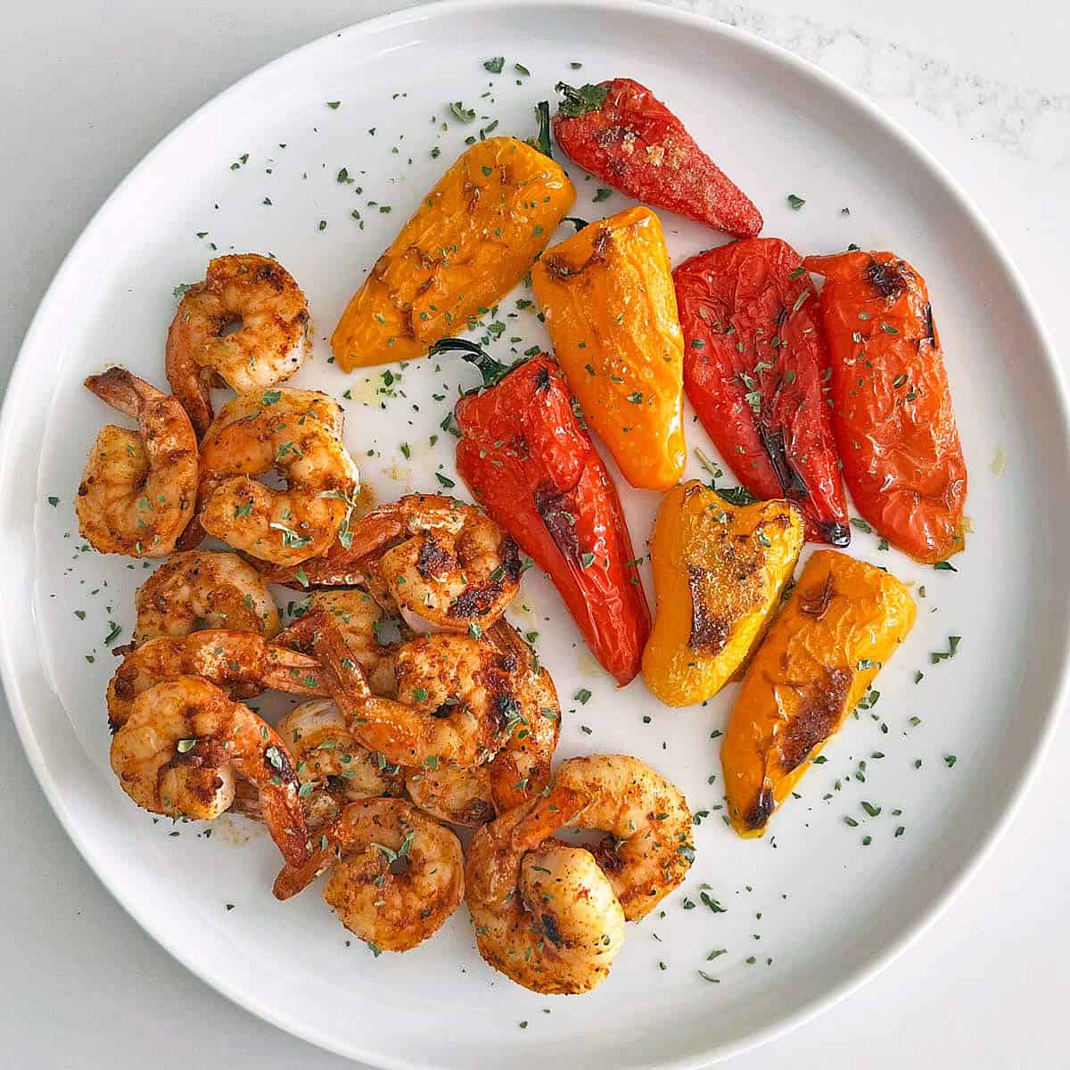 Grilled shrimp served with mini peppers.
