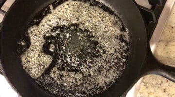 Heating coconut oil in a skillet.