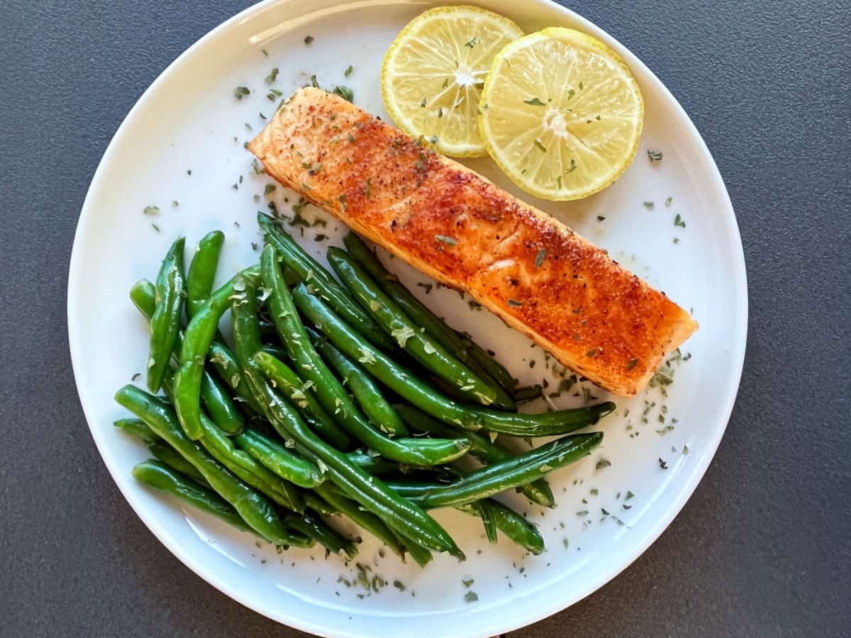Pan-fried salmon served with sauteed green beans.