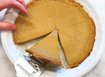 Slicing the pie and lifting the slices out of the pan.