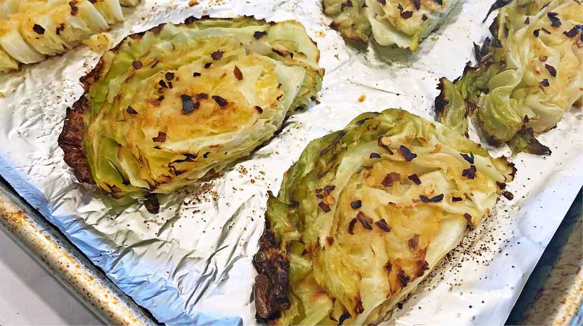 Roasted cabbage on a baking sheet.