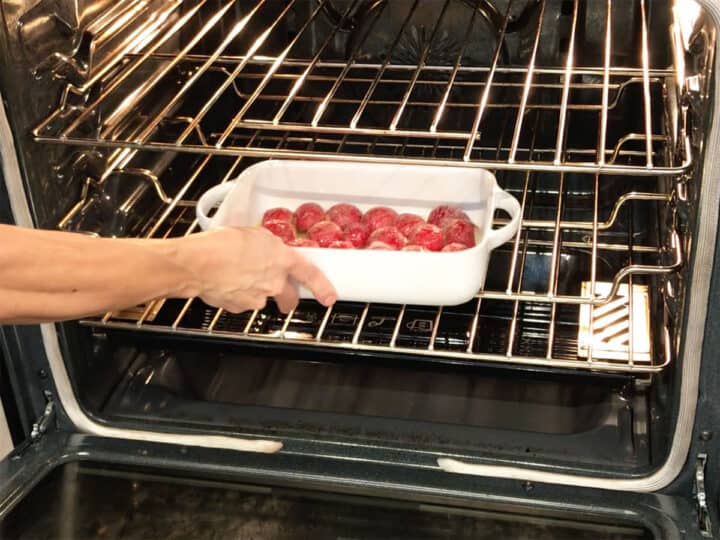 Placing the radishes in the oven.