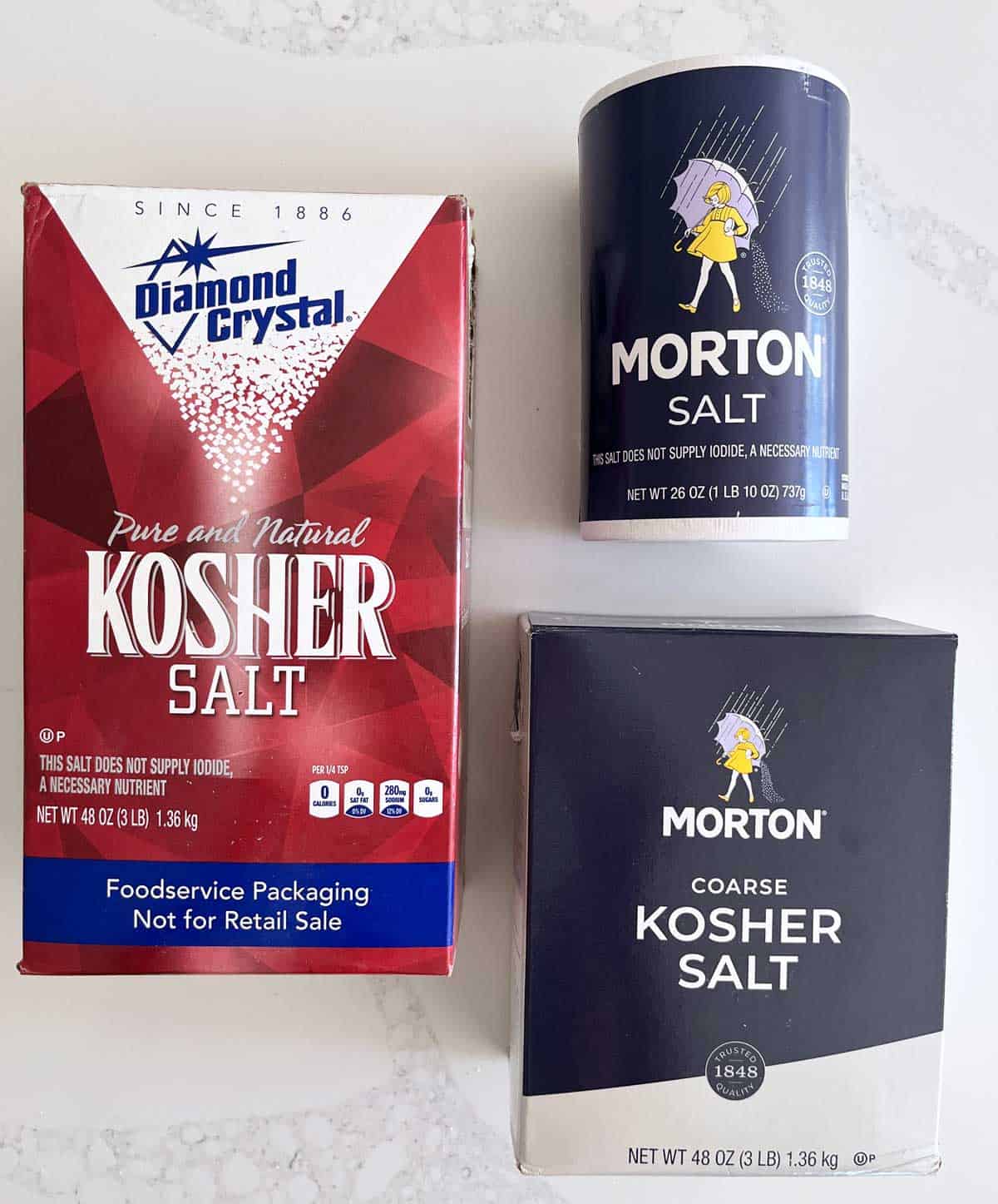 Three salt packages: Diamond Crystal, Morton kosher salt, and Morton table salt. 