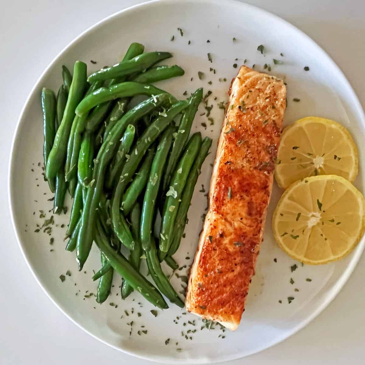 Sauteed green beans paired with pan-fried salmon.