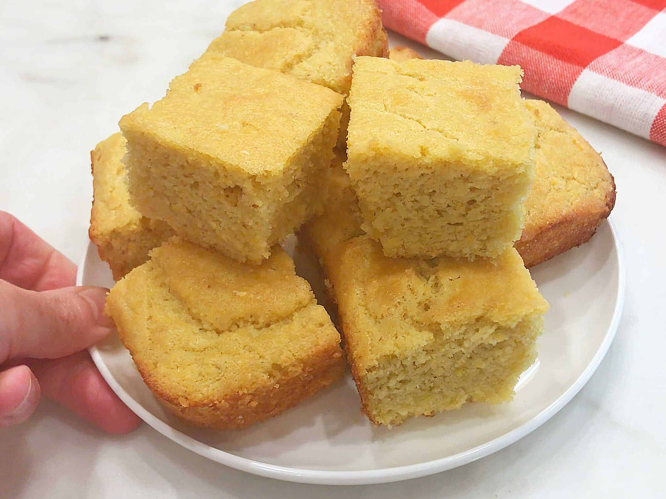 Serving the cornbread on a white plate. 
